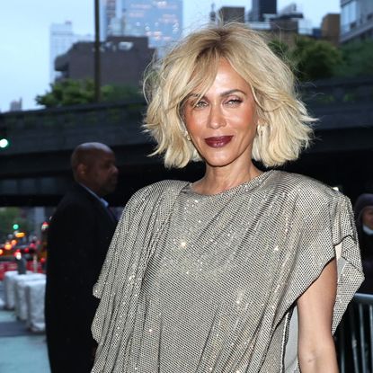 Nicole Ari Parker with a short blonde bob and dark purple lipstick