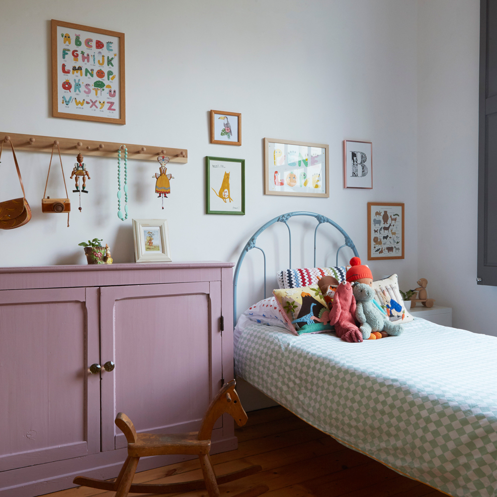 girls bedroom with bed and purple cupboard