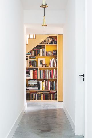 yellow staircase with built in bookcase