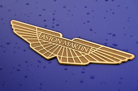 A gold Aston Martin Valkyrie hypercar logo bonnet badge