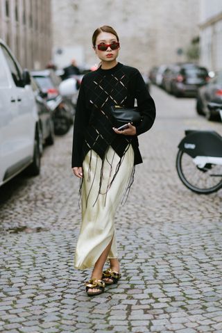 woman in slip maxi skirt and oversized sweater