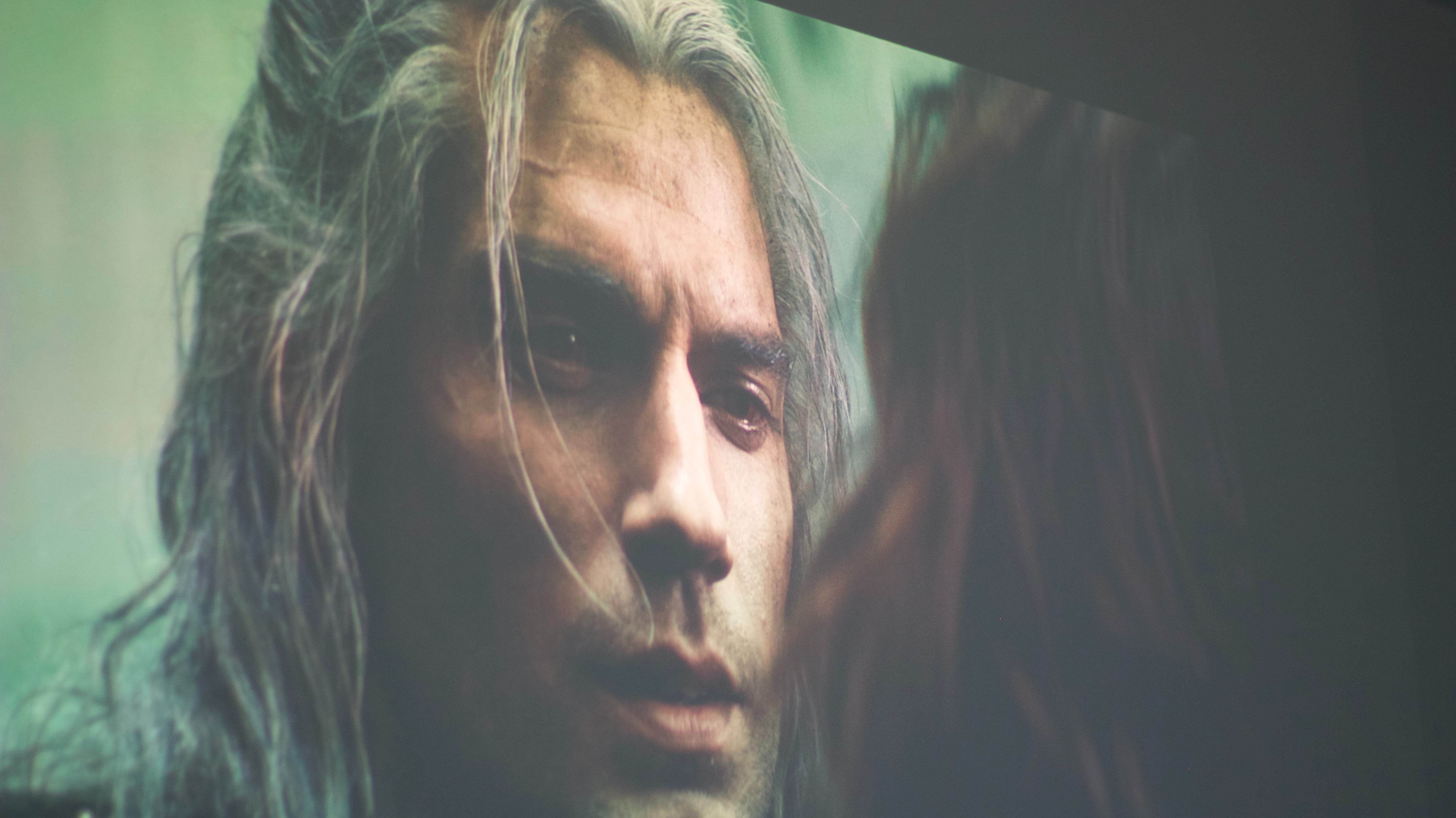 Geralt from the witcher cast on a projector screen