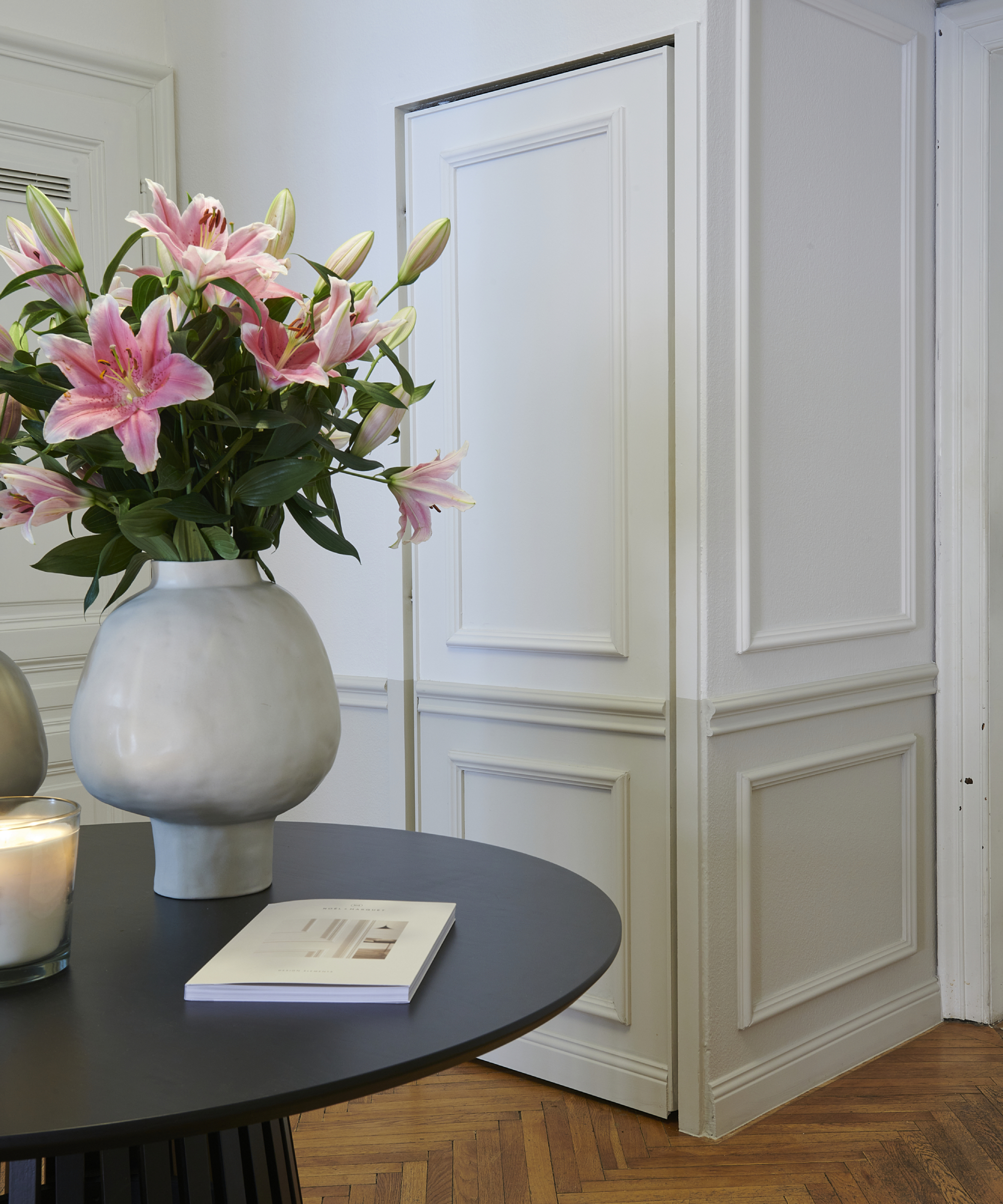 hallway with wooden panelling detail on walls and hidden door