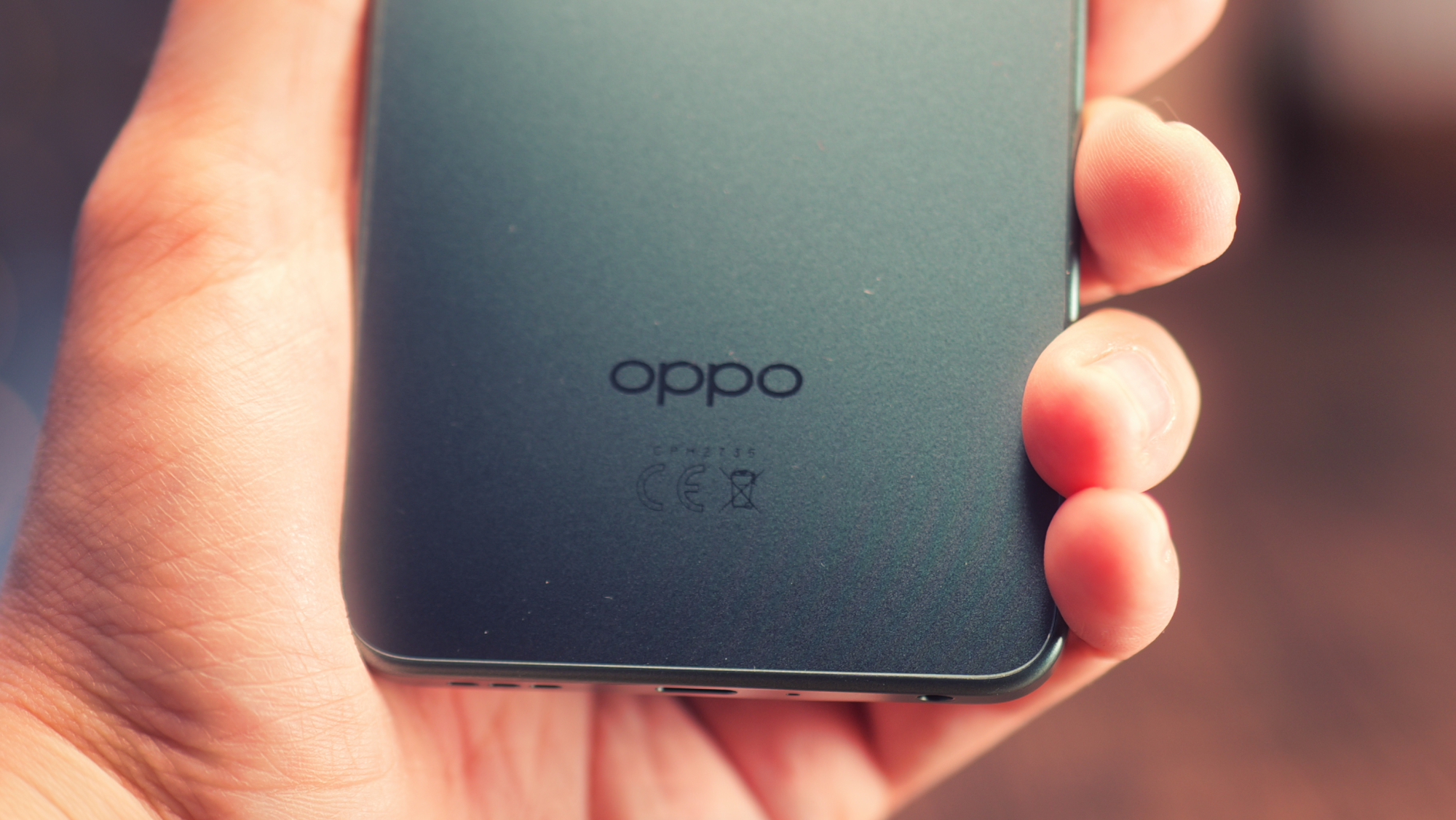 Oppo A5 5G phone held in a hand