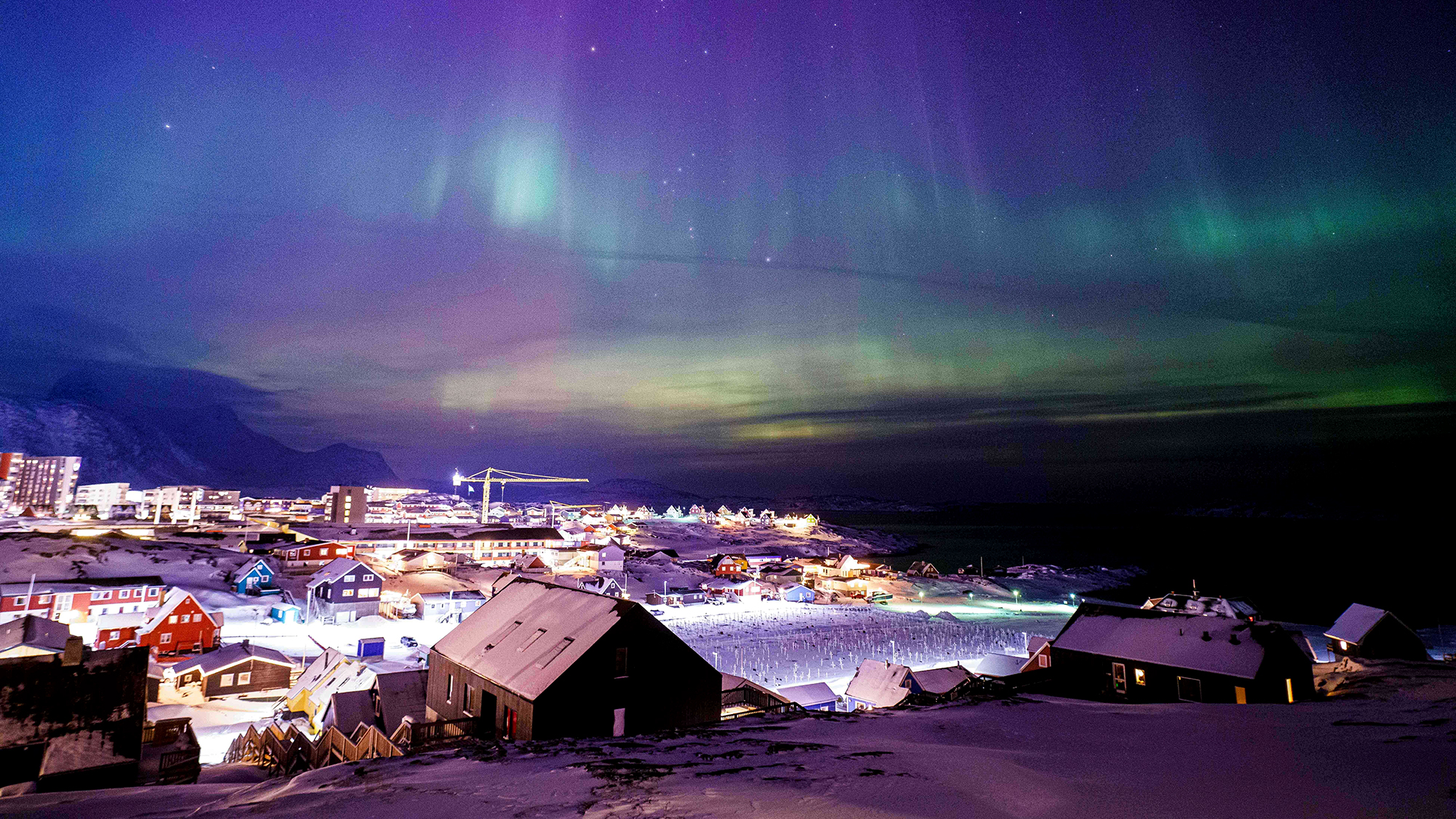 The northern lights shimmer above the capital city of Nuuk, Greenland