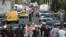 Police and forensic officers attend the scene of a multiple stabbing attack in Southport, Merseyside