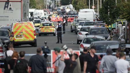 Police and forensic officers attend the scene of a multiple stabbing attack in Southport, Merseyside