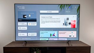 LG B4 OLED TV on table in living room