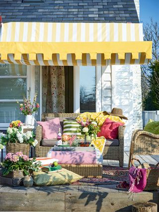 awning ideas: yellow striped awning over patio