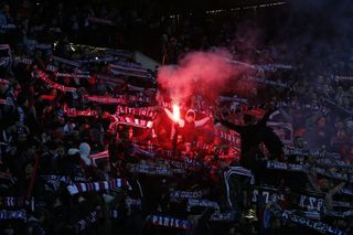 Paris Saint-Germain's supporters cheer with flares and flags during the French L1 football match between Paris Saint-Germain (PSG) and Marseille (OM) at the Parc des Princes in Paris on February 25, 2018.