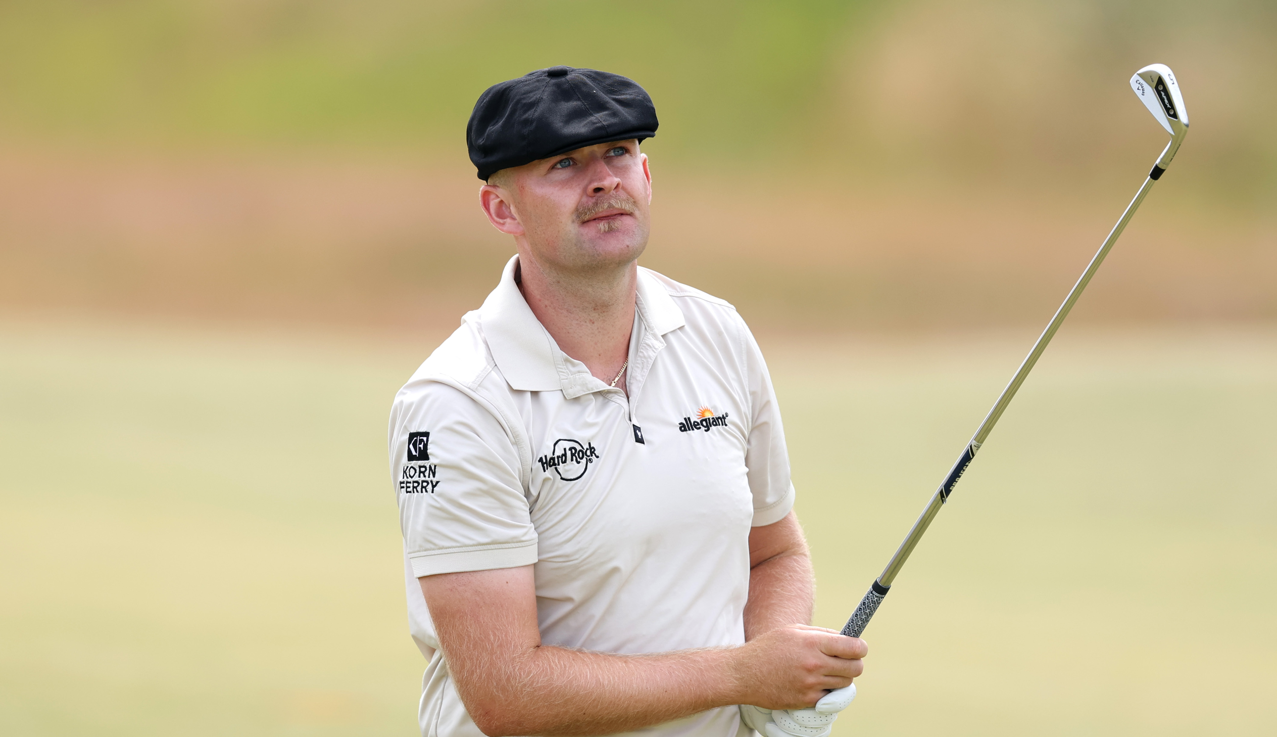 Harry Hall hits an iron and watches it in the air