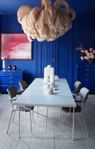 A small dining with deep blue walls