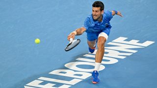 Novak Djokovic stretches for a shot at the Australian Open 2023