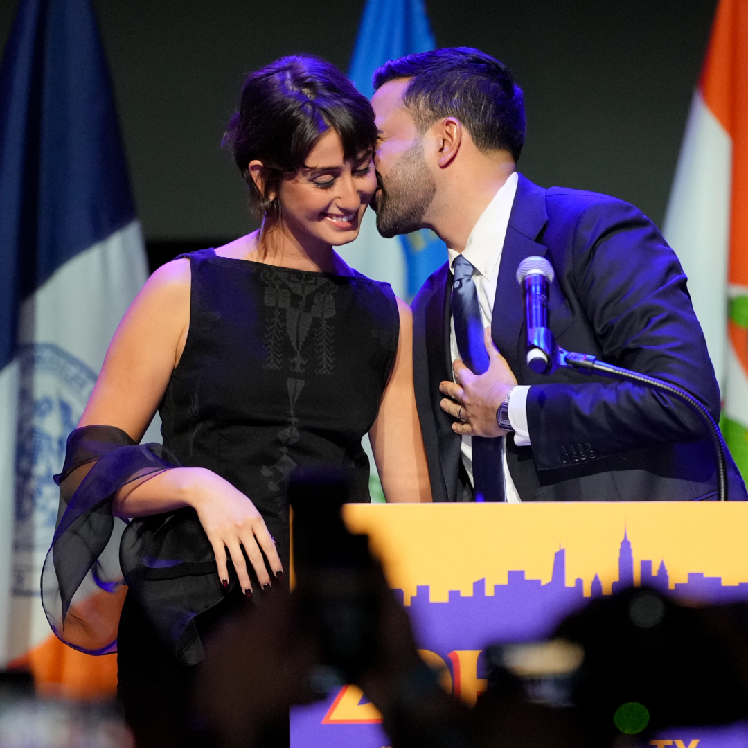 Rama Duwaji wearing a high neck top from a Palestinian designer onstage at the mayoral election