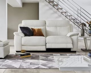 A white leather recliner sofa in a modern living room
