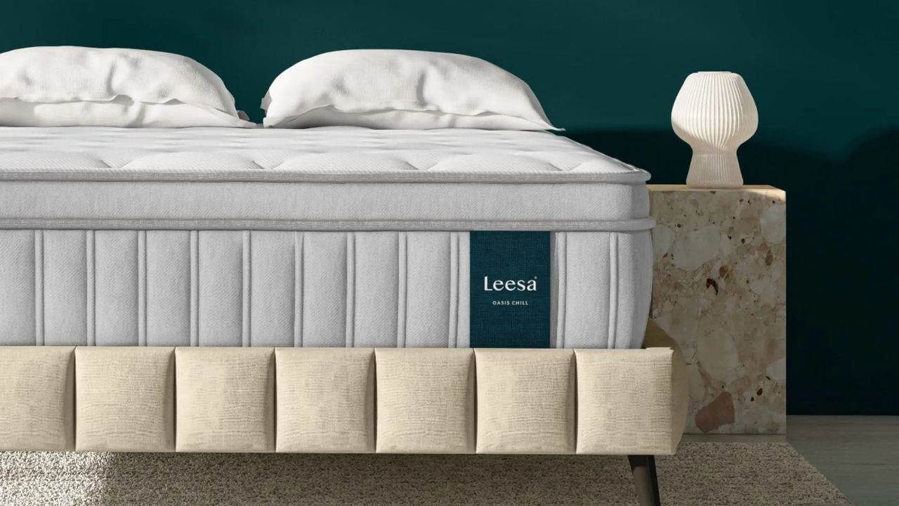 Leesa Oasis Chill Hybrid Mattress on a bed against a teal wall. 