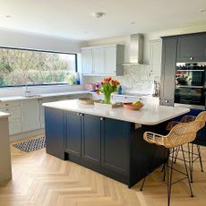 Kitchen painted with white walls and navy and grey cabinets