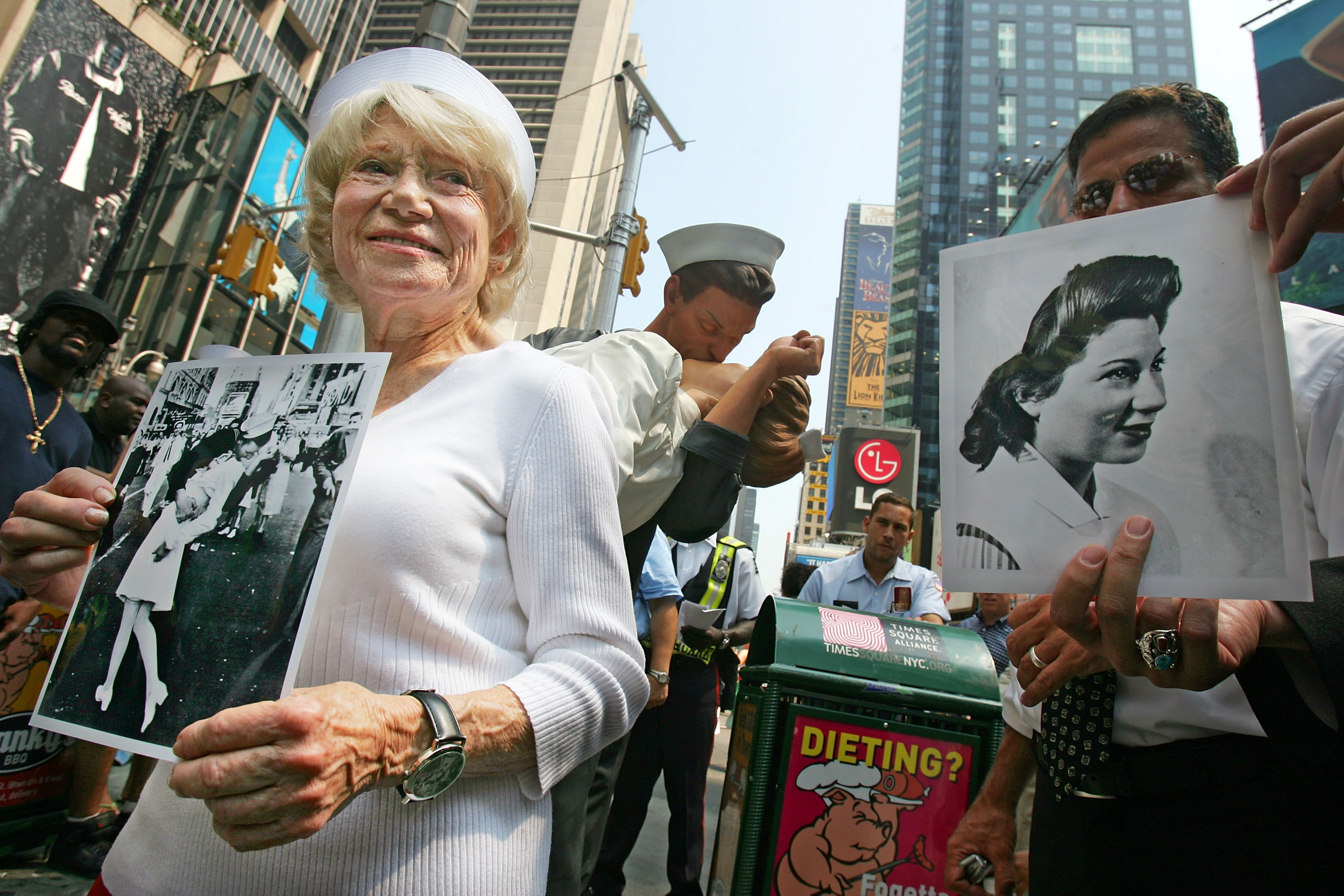 NEW YORK - AUGUST 11: Eighty six-year-old Edith Shain stands in Times Square to welcome a statue of her famous kiss with a sailor on V-J Day at the end of World War II August 11, 2005 in New York City. The famous kiss was photographed by Alfred Eisenstaedt and the unveiling of the statue coincides with the 60th anniversary of the end of World War II on August 14, 1945. The sailor in the photograph has never been positively identified. (Photo by Mario Tama/Getty Images)