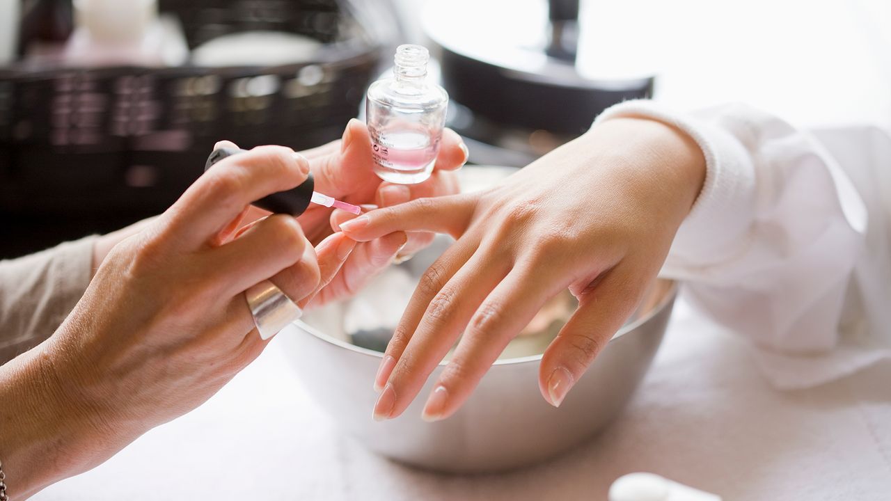 close up of woman having nails painted