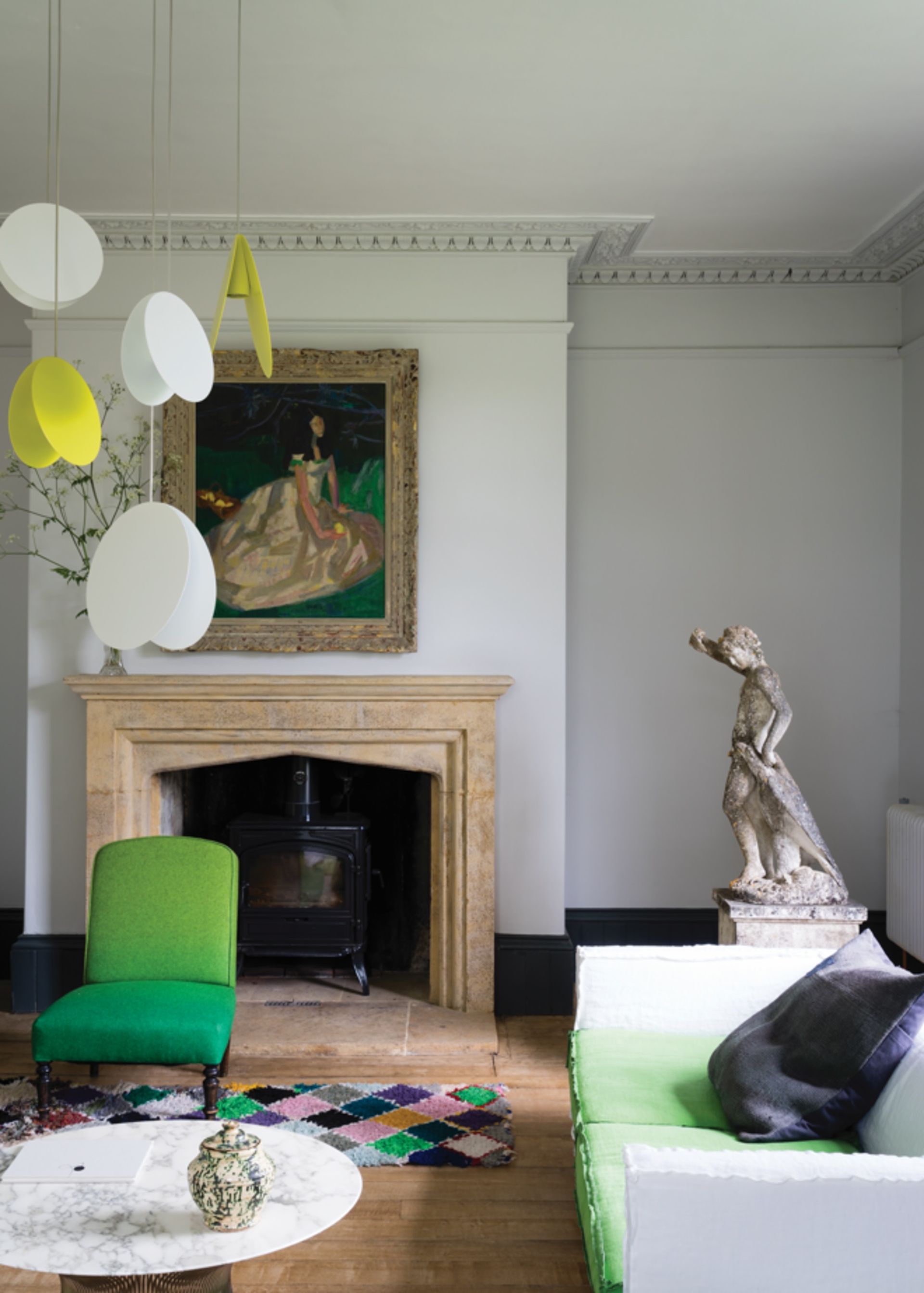 A grey living room with green pops of color