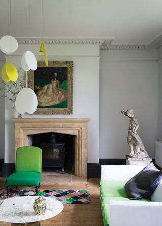 A grey living room with green pops of color