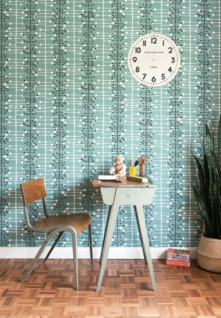 A study space with a blue pattern wallpaper