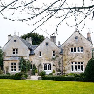 house exterior with white windows and garden