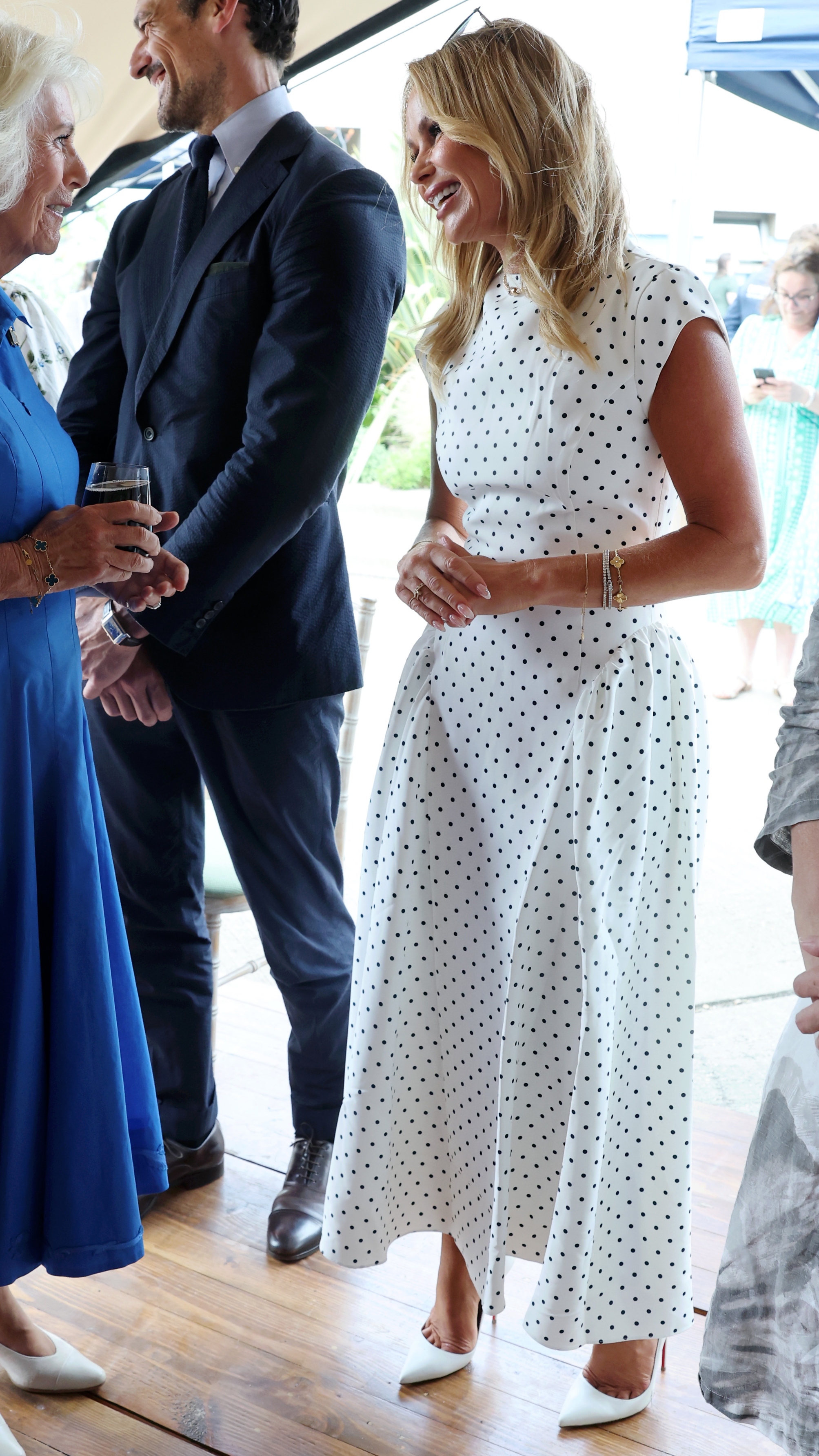 Queen Camilla speaks with David Gandy and Amanda Holden during a visit to unveil the new RHS and BBC Radio 2 'Dog Garden', designed by Monty Don at Battersea Dogs & Cats Home on July 14, 2025