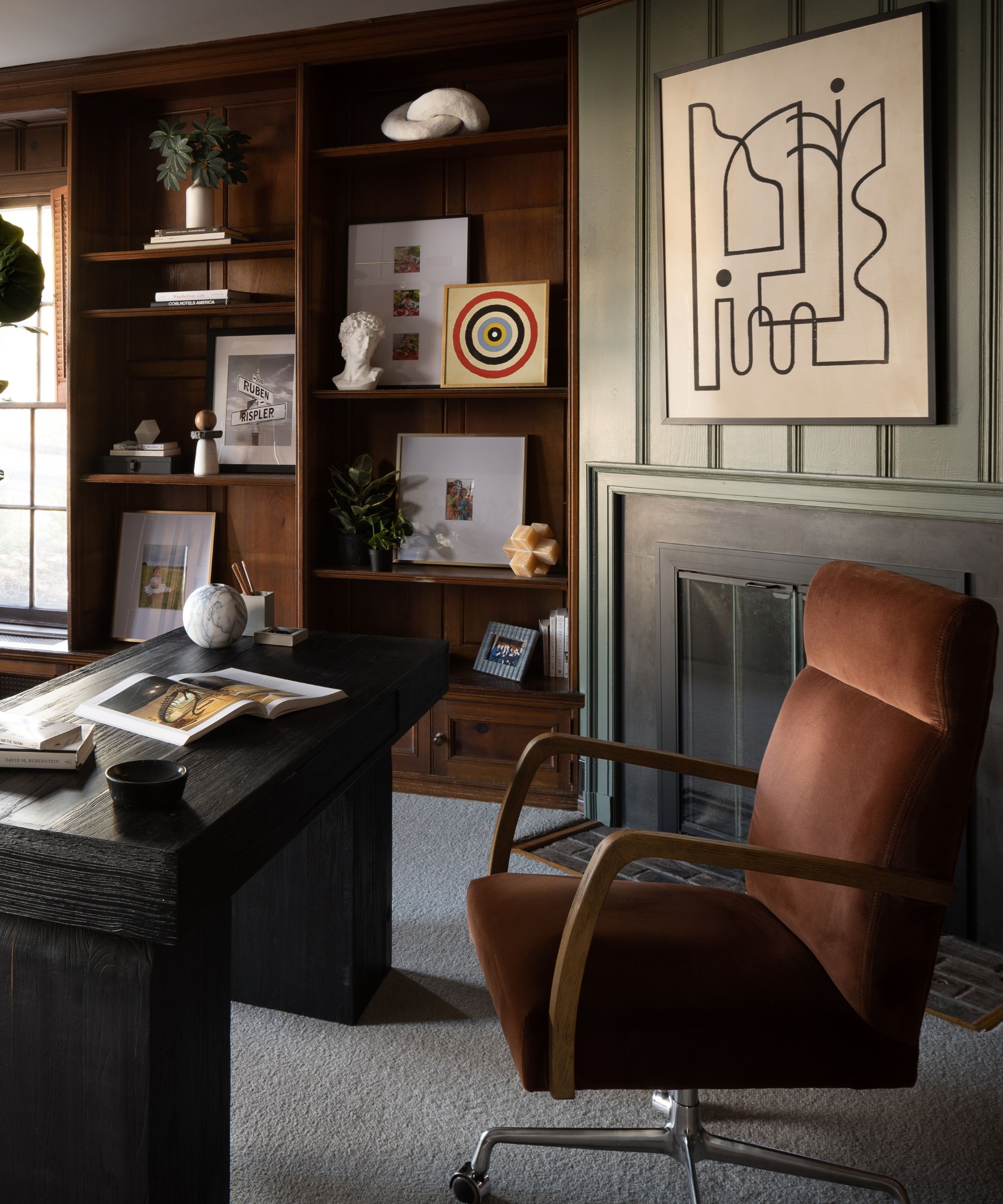 Office space dark and moody with brown and green accents