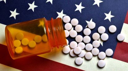 Prescription pill bottle on American flag