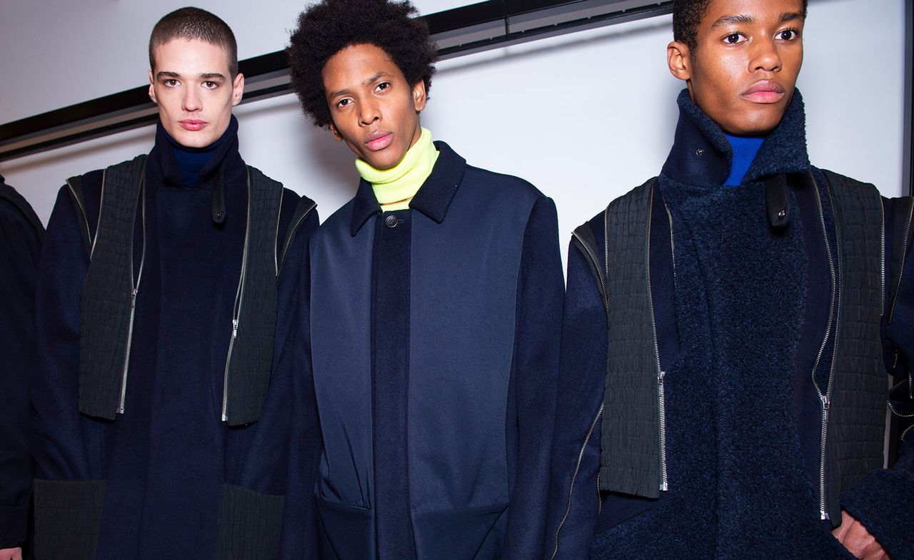 Three male models modelling Chalayan clothing in shades of blue.