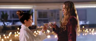 Anna Kendrick as Stephanie and Blake Lively as Emily toast martinis in Another Simple Plan