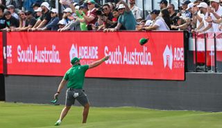 Dean Burmester throws hats to the fans at LIV Golf Adelaide