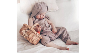 A sleeping baby holds a Personalised Easter Basket from Not on the High Street - one of this year's best Easter baskets