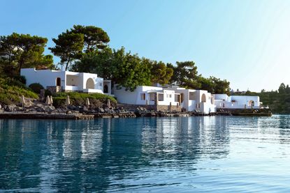 White bungalows sit on glistening coastline