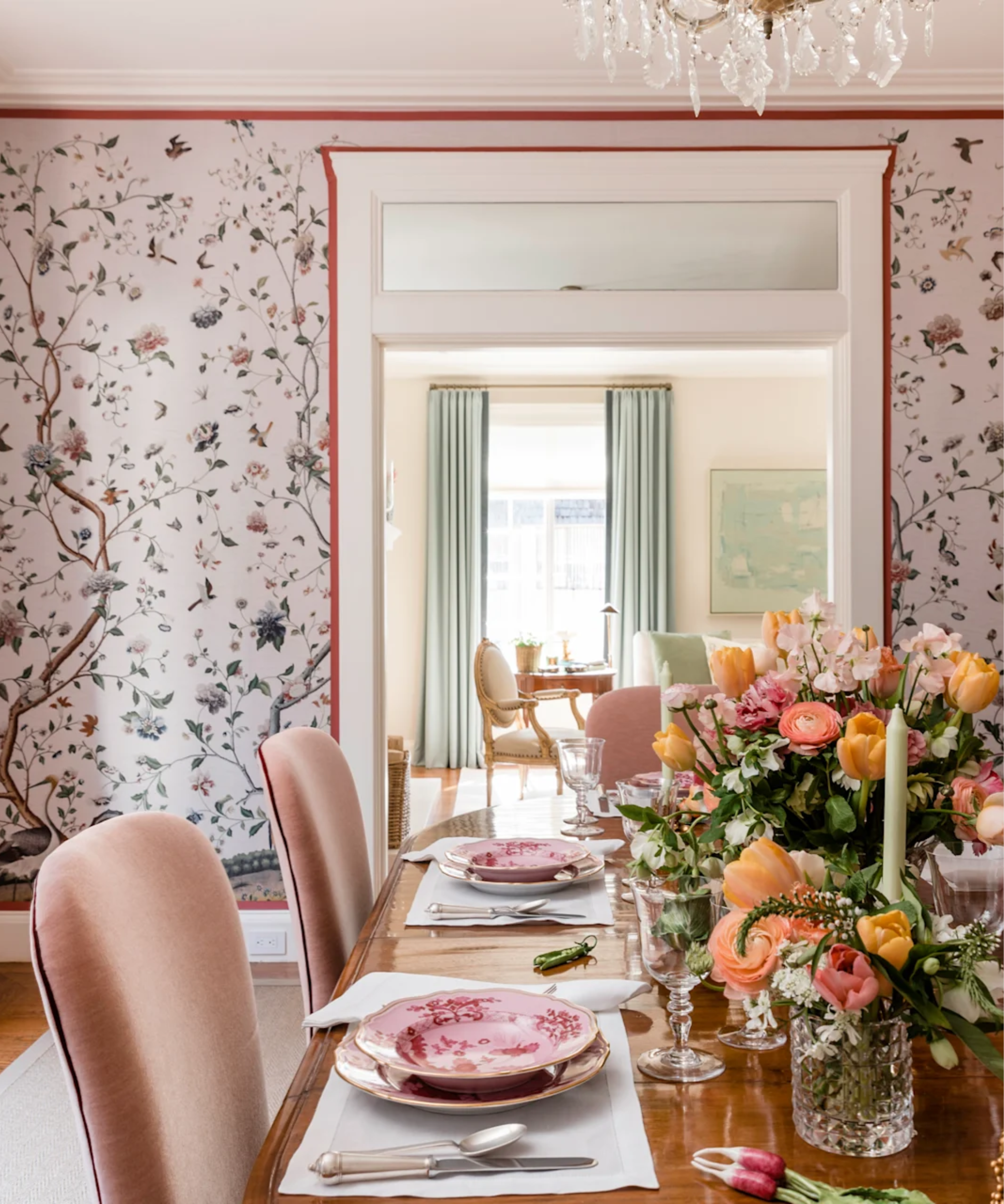 Pink table setting with orange flowers and candles