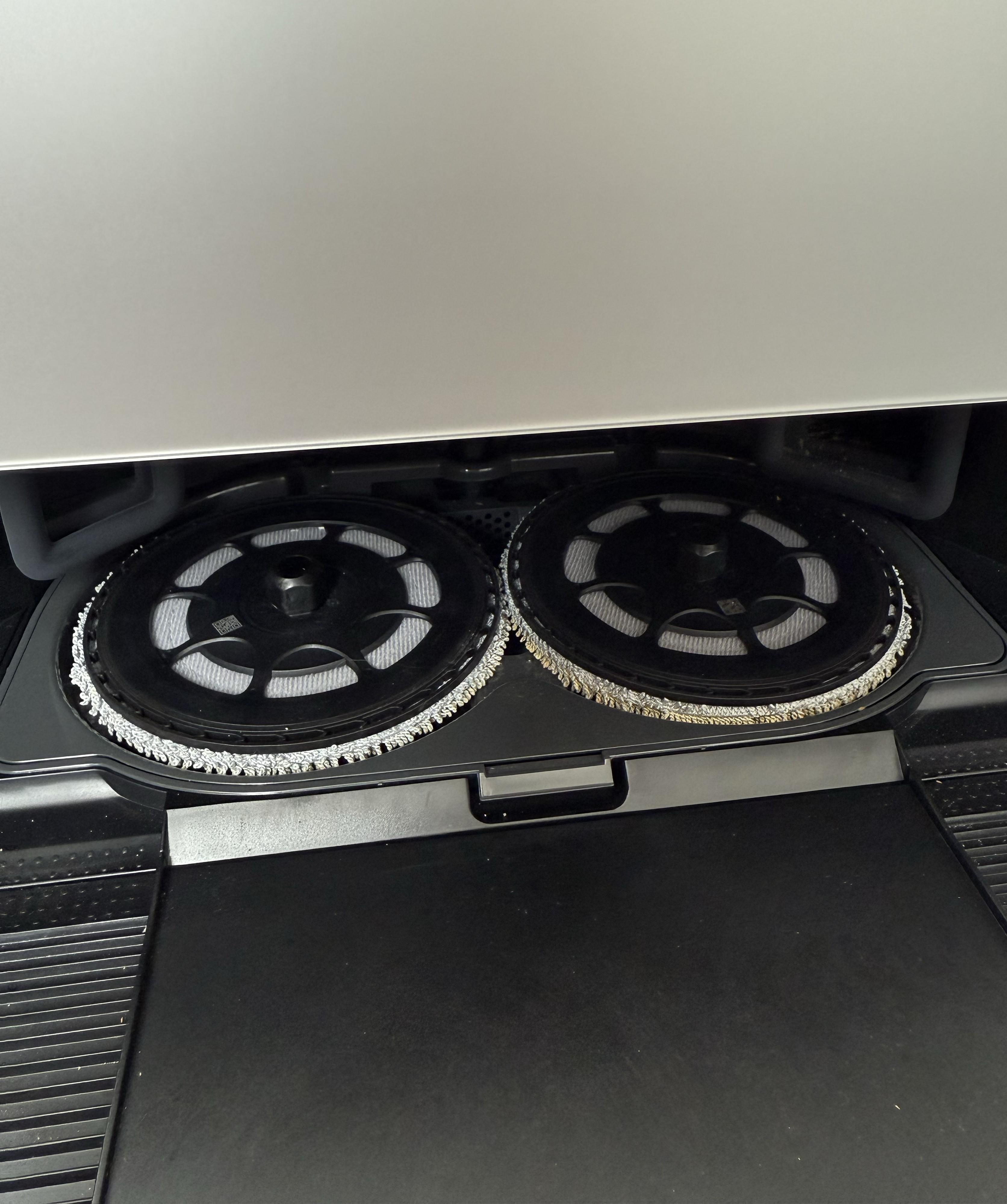 Inside the Roborock Saros Z70 cleaning station, revealing round discs for washing and drying mop pads