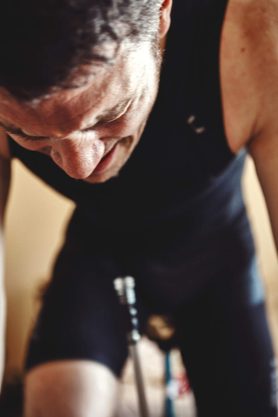 A cyclist strains while training indoors