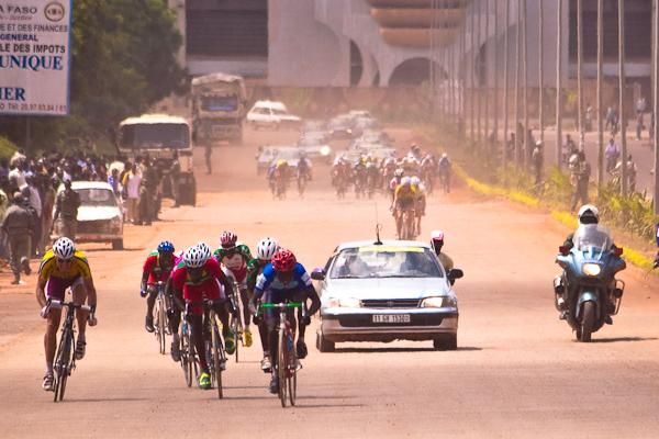 The remnants of the breakaway sprint for second as the peloton kicks up dust.