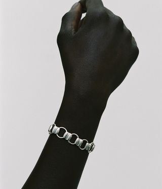 gold and silver bracelet on wrist