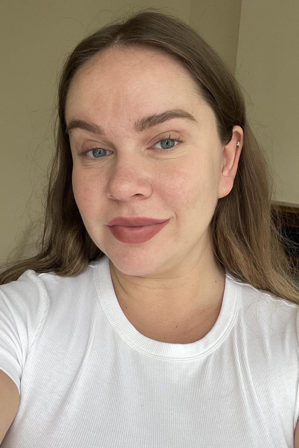 Valeza wearing the lippie stick over a neutral lipstick