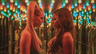 Riley Keough and Taylour Paige facing off in a mirrored hallway in Zola.