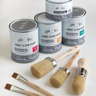 Three thins of Annie Slone paint with three wooden paint brushes