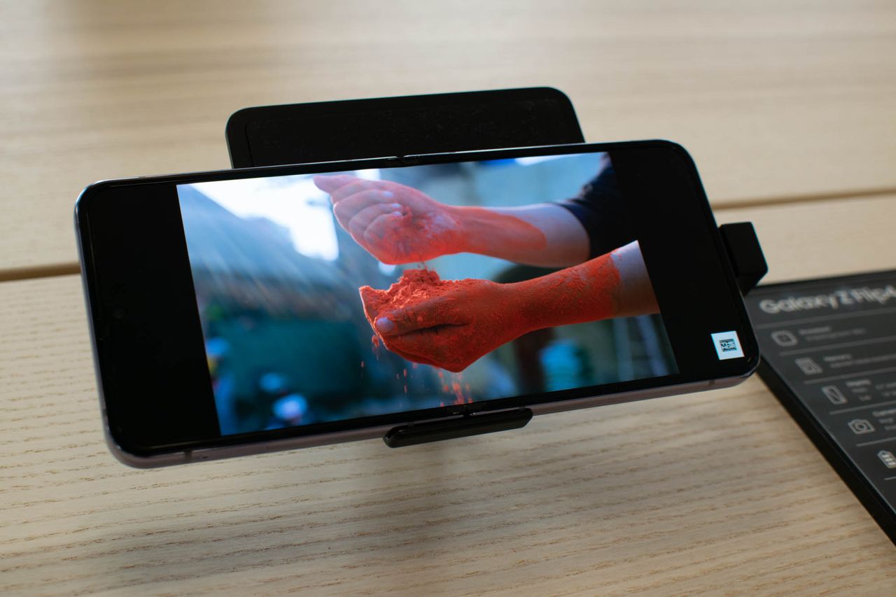 A photograph of the Samsung Galaxy Z Flip 4 playing a video