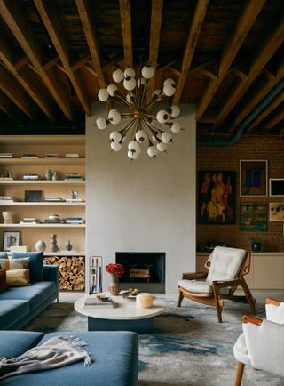 A living room with wooden beams and Sputnik chandelier centerpiece