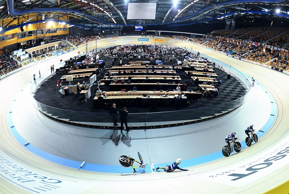 France's Marie Le Net (C) falls during the Women's Team Pursuit qualifying round during the UCI Track Cycling World Championships in Apeldoorn