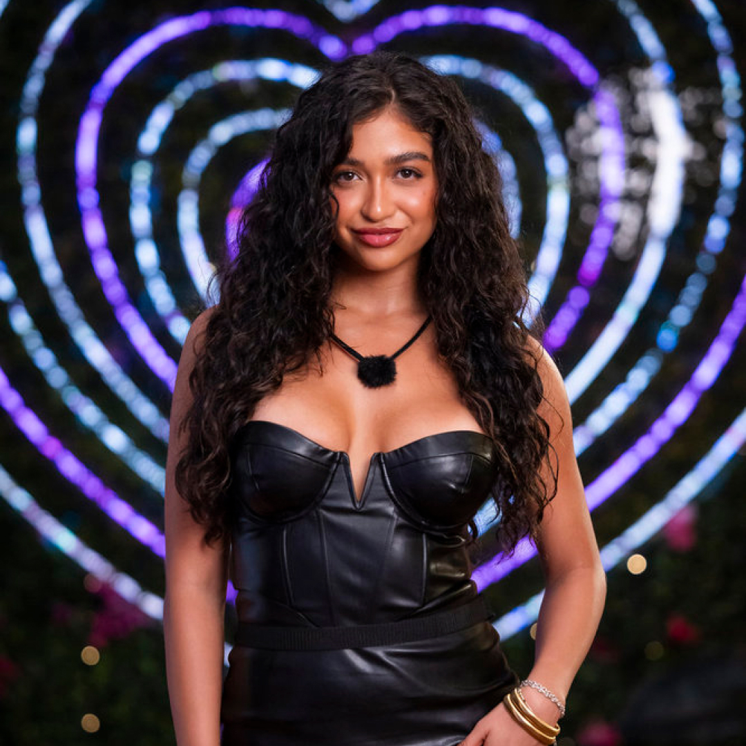 Cierra Ortega, standing in front of a neon heart sign, in 'Love Island USA' season 7.
