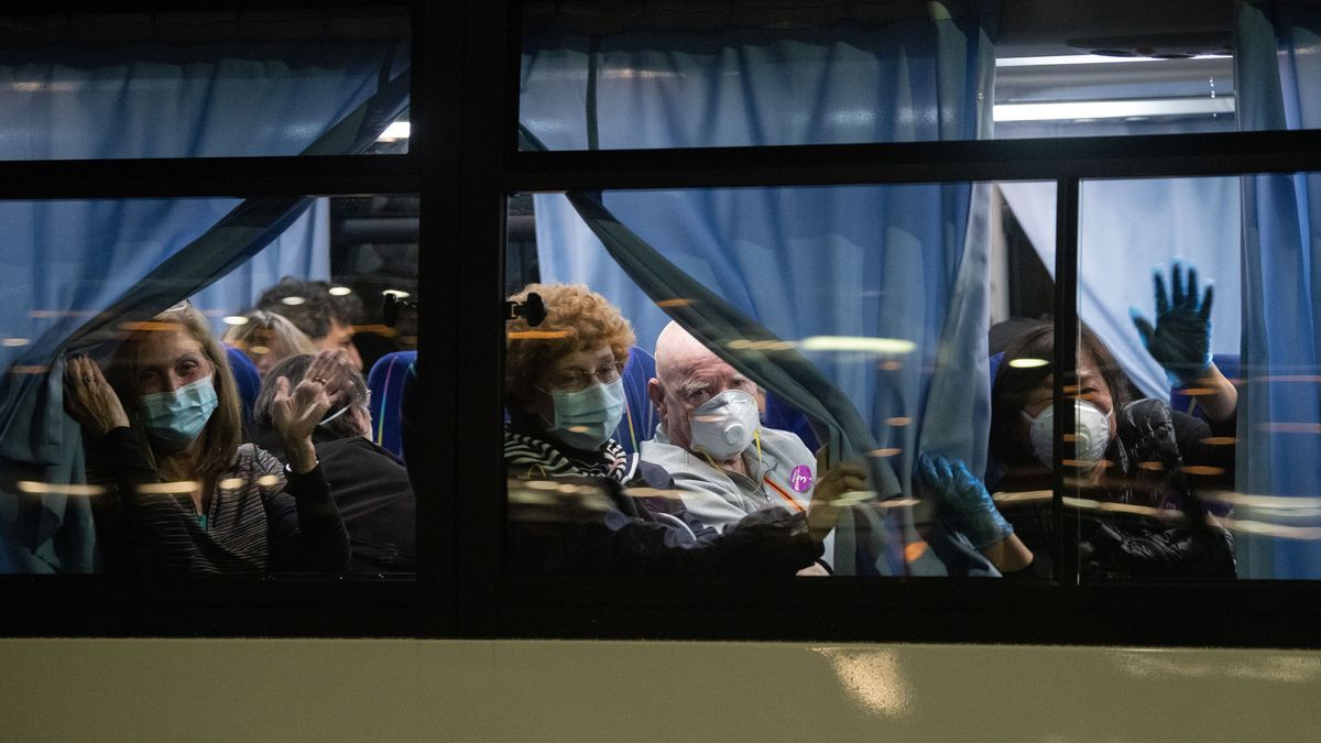 American citizens wave from a bus as they leave the quarantined Diamond Princess cruise ship at Daikoku Pier to be repatriated to the United States on Feb. 17, 2020 in Yokohama, Japan.