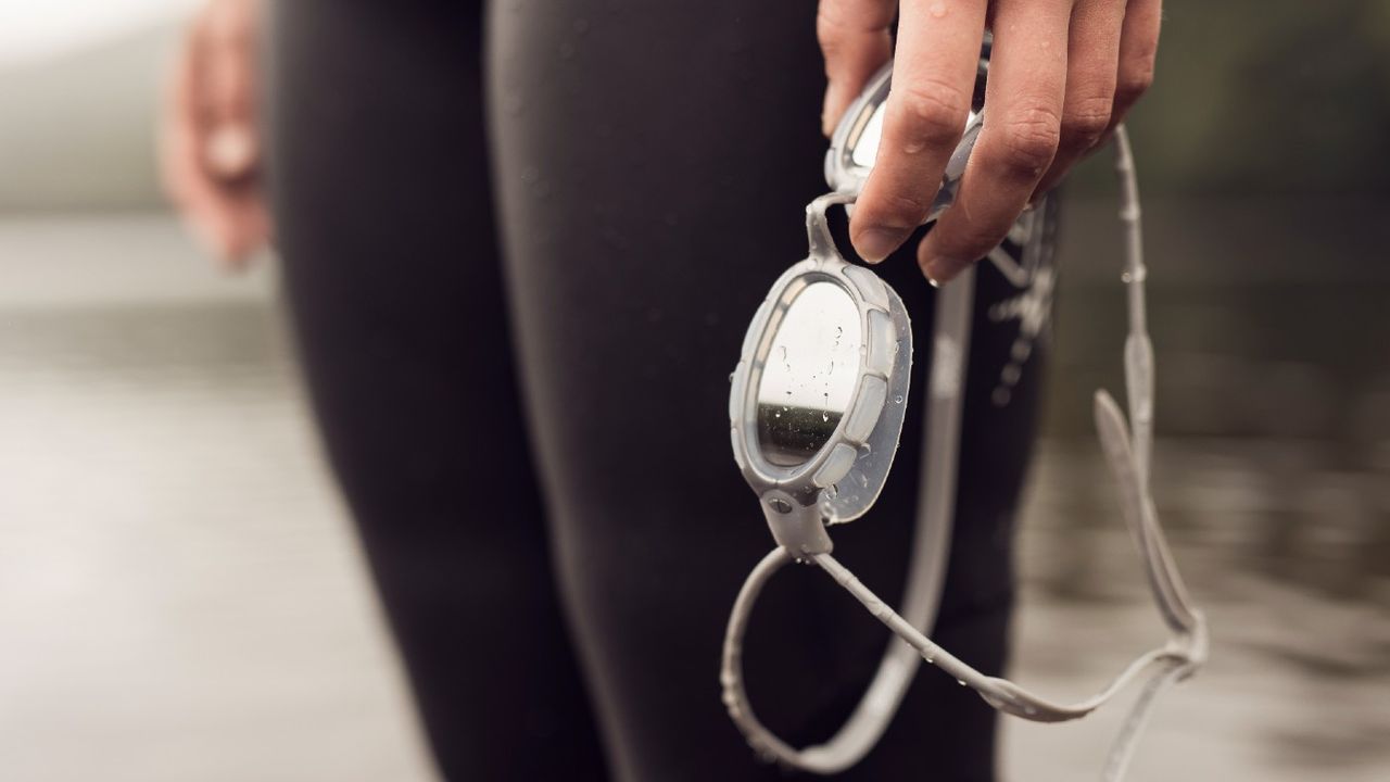 Person holding pair of goggles