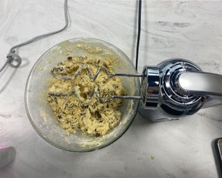 Image of Dualit hand mixer being used in a test to create cookie dough